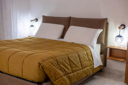 a bedroom with a large bed with two pillows at BeB Domus Arbenzio San Giovanni Suite in Rome