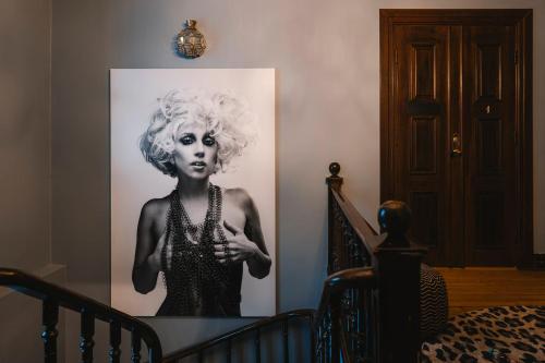 a black and white picture of a woman on a wall at Köpmans Boutique Hotel & Bistro in Höganäs
