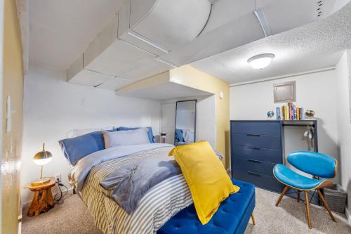a bedroom with a blue bed and a blue chair at Cozy, Quiet 3BR Sugar House Hideaway by Mountains, Wi-Fi & Parking in Salt Lake City
