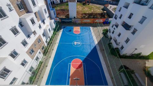 an overhead view of a basketball court between two buildings at House AS Buxton in Mombasa