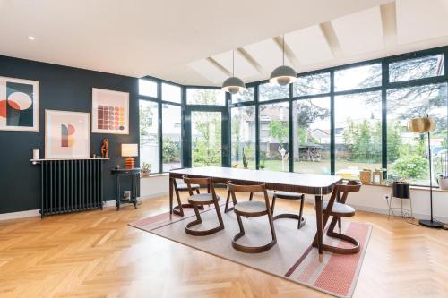a dining room with a table and chairs at Green Place - Amazing house with swimming pool in Caluire-et-Cuire