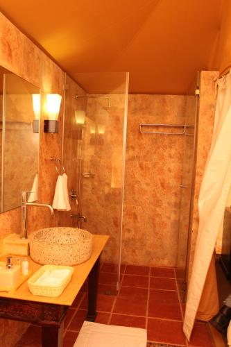 a bathroom with a shower and a sink at Serena Beach Resort in Mandvi