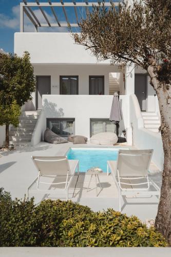 a patio with chairs and a swimming pool at Villa Amy Agios Prokopis in Agios Prokopios