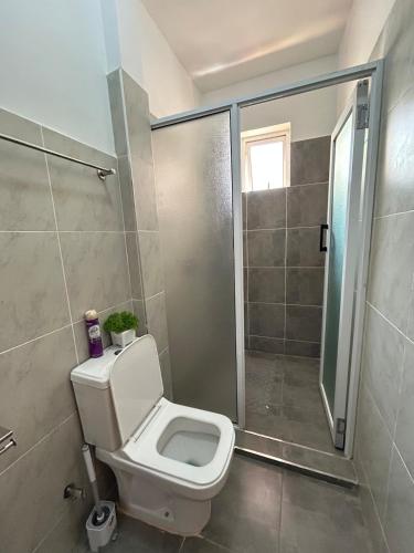 a bathroom with a toilet and a shower at Secret Serenity - Modern, Stylish & Comfy 2 Bedroom Apartment With Workspace, Secure Parking, CCTV, Swimming Pool, Gym, And City Views in Nairobi in Nairobi