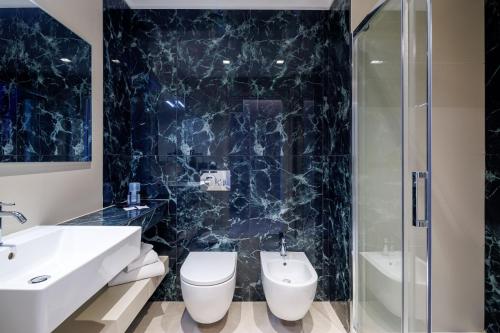 a bathroom with a sink toilet and a shower at Casa San Giuseppe in Rome