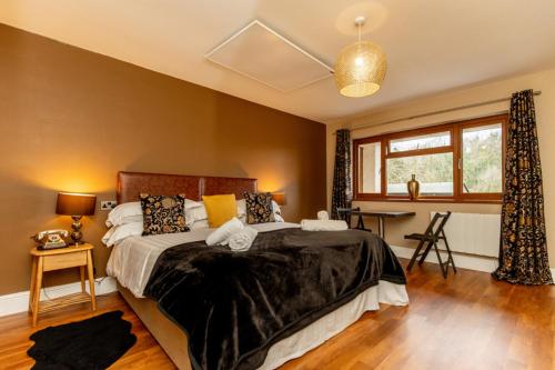 a bedroom with a large bed and a window at The Gower Hotel in Swansea