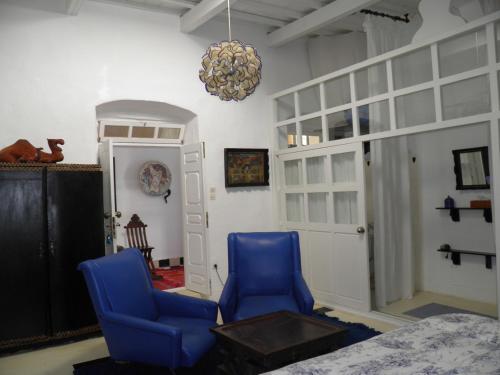 two blue chairs and a table in a room at La Maison des Artistes in Essaouira