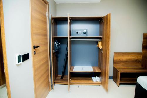 a room with a closet with a wooden door at New Amaan Hotel in Zanzibar City