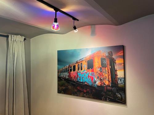 a painting of a train hanging on a wall at Stay Nice Thermen-Glück 3BR 100qm Whirlpool-Badewanne in Bad Aibling