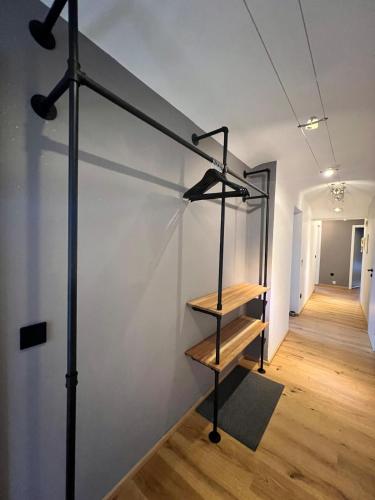 a staircase in a room with a white wall at Stay Nice Thermen-Glück 3BR 100qm Whirlpool-Badewanne in Bad Aibling