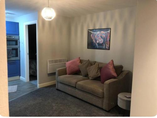 a living room with a couch and a painting on the wall at Captivating 1-Bed Apartment in Hednesford in Cannock