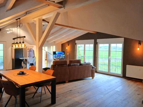 a living room with a table and a couch at Hof Sorgenfrei in Buch