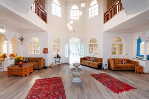 a large living room with couches and rugs at Palais Rhize targa in Marrakech