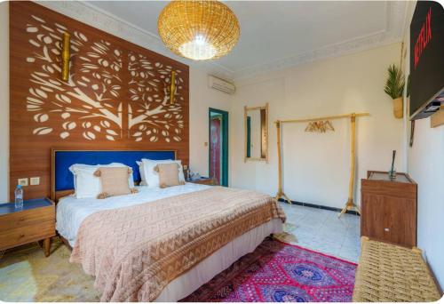 a bedroom with a large bed with a wooden wall at Palais Rhize targa in Marrakech