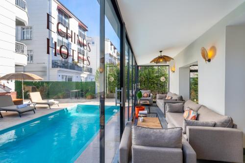 a swimming pool in the middle of a living room at Echinus Lara Hotel in Antalya