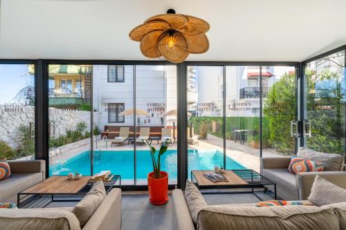 a living room with couches and a pool at Echinus Lara Hotel in Antalya