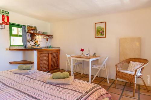 a bedroom with a bed and a table and chairs at El Sitio in Frontera