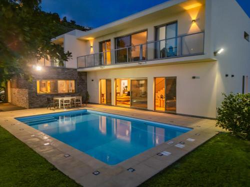 a large swimming pool in front of a house at THE OLD CHAPEL HOUSE in Funchal