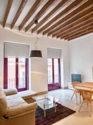 a living room with a couch and a table at LovelyLoft Castaños in Alicante