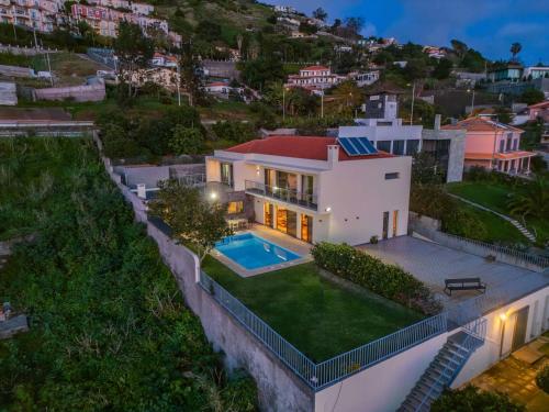 an aerial view of a house with a swimming pool at THE OLD CHAPEL HOUSE in Funchal