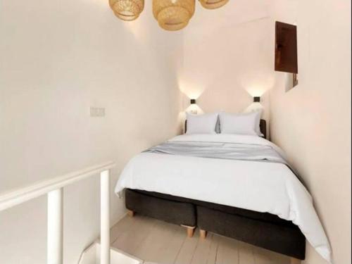 a bedroom with a bed in a white room at LovelyLoft Santa Cruz in Alicante