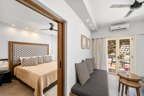 a bedroom with a bed and a table at Glaros Hotel Apartment in Agia Galini