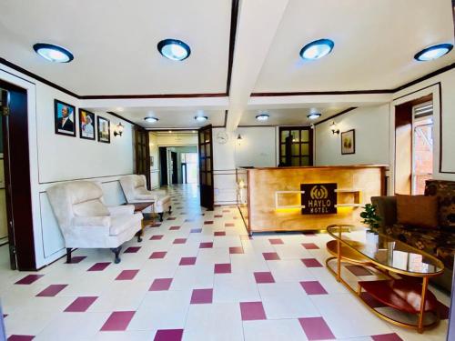 a living room with a checkered floor at Haylo Hotel in Kampala