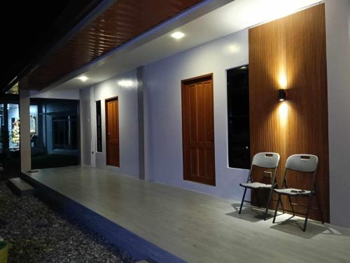 a room with two stools on the side of a house at Wilson Hills Travelers Suites in San Juan
