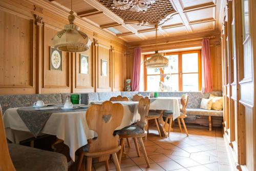 a dining room with a table and chairs at Hotel Bichlhof in Reit im Winkl