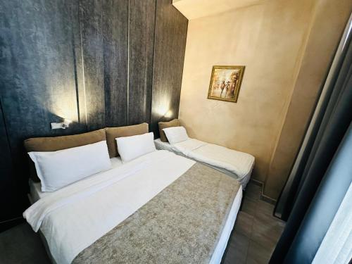 a bedroom with two beds with white pillows at Colombia Apartments&Rooms in Durrës