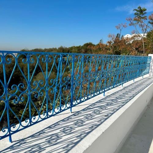 a blue metal railing on top of a bridge at Dar Kbira - Sidi Bou Said in Sidi Bou Saïd