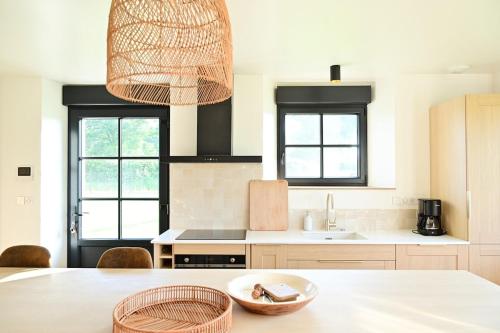 a kitchen with a table with a bowl on it at La Grange et le Nid in Saint-Pierre-des-Nids