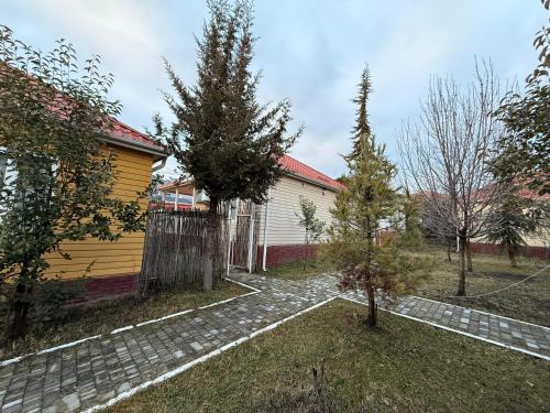 a house with a fence and trees in the yard at Gabala Homes Musa in Gabala
