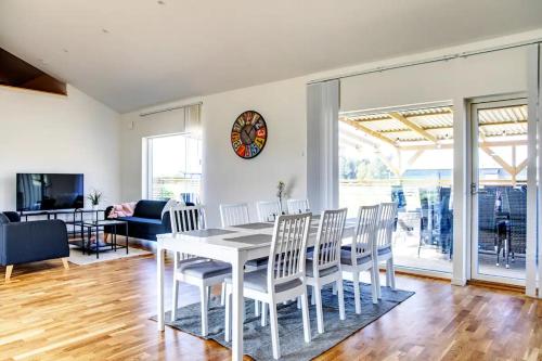 a dining room with a white table and chairs at Visby Villas in Visby