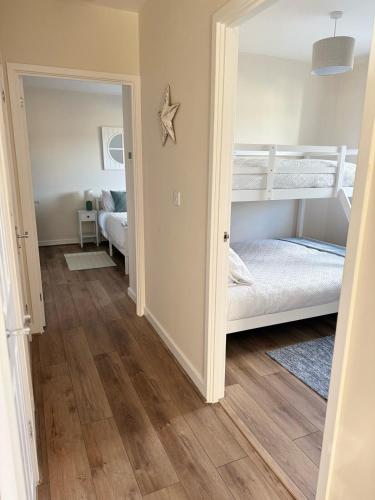 a room with two bunk beds and a hallway at Sea Spire Coach House in Charlestown