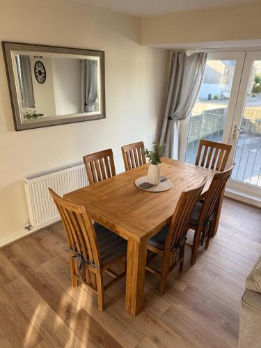 a dining room with a wooden table and chairs at Sea Spire Coach House in Charlestown