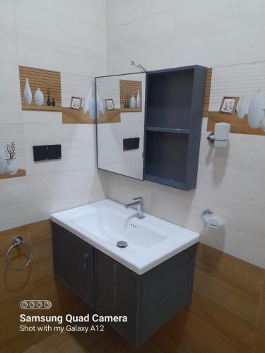 a bathroom with a sink and a mirror at Trinco Harbour Villa in Trincomalee