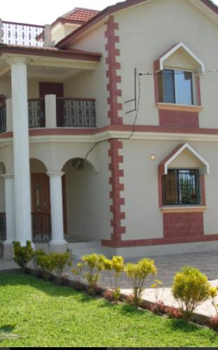 a house with a lawn in front of it at Paradise Estate in Gambia in Old Yundum
