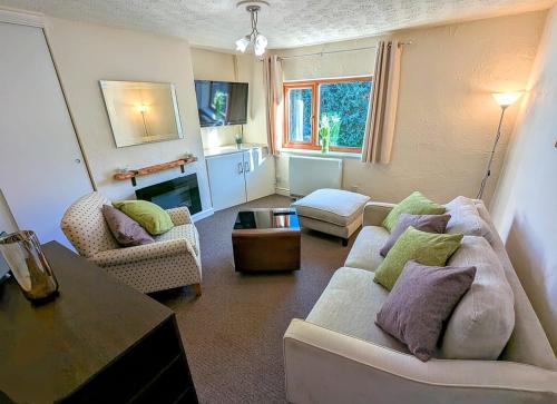 a living room with a couch and two chairs at Cosy Country Styled Apartment in Kidsgrove