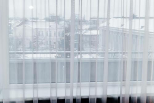 a view of a city through a window with bars at Pärnu Hotel in Pärnu