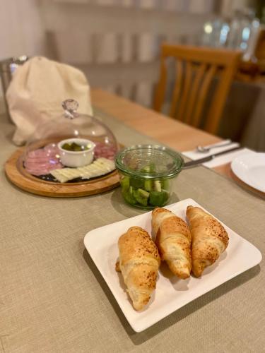 a table with a plate of food on a table at B&B Brezov Gaj in Kranjska Gora