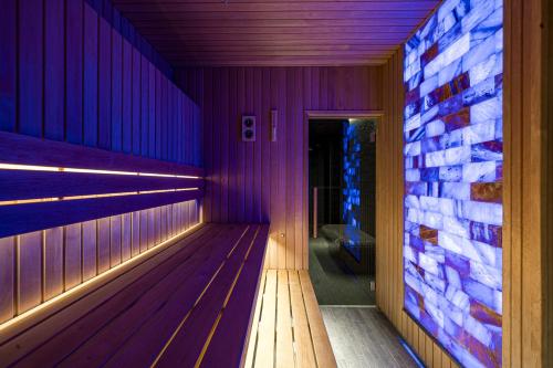 an empty sauna with purple lights on the wall at Grand Baltic Dunes Hotel & SPA in Palanga