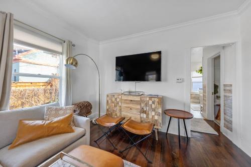 a living room with a couch and a table at Urban Escape by Mountains w/3BR, Wi-Fi, Laundry in Salt Lake City