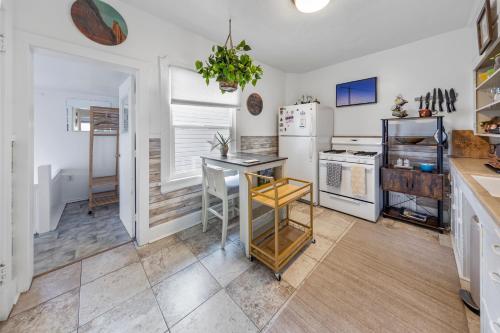 a kitchen with a table and a refrigerator at Urban Escape by Mountains w/3BR, Wi-Fi, Laundry in Salt Lake City