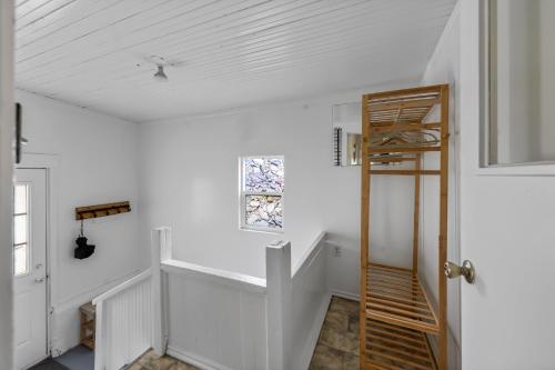a white room with a staircase and a ladder at Urban Escape by Mountains w/3BR, Wi-Fi, Laundry in Salt Lake City