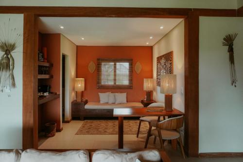 a bedroom with a bed and a desk in a room at Jaguaríndia Village in Fortim