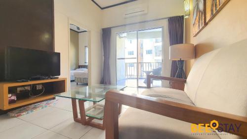 a living room with a couch and a tv at Gold Coast Morib Studio l Apartment I Penthouse in Banting
