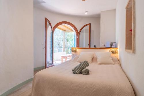 a bedroom with a bed with a pillow on it at Casa Tuna - Beach 100m - Cala Llombards in Santanyi
