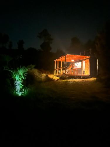 a small house lit up at night at Alcmaria studio with amazing views! in Folhadosa