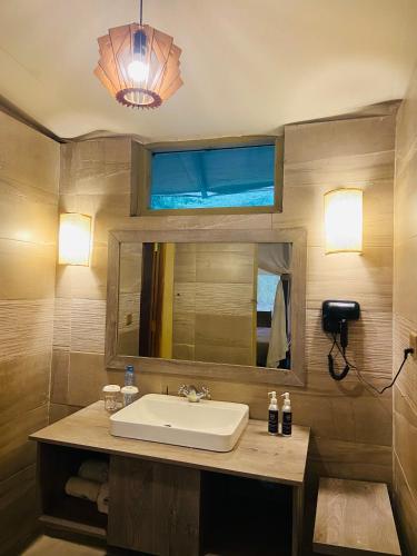 a bathroom with a sink and a mirror at Mara Sweet Acacia Lodge in Talek